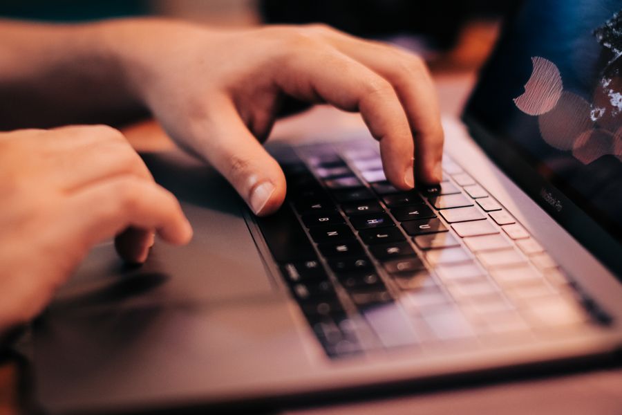person typing laptop